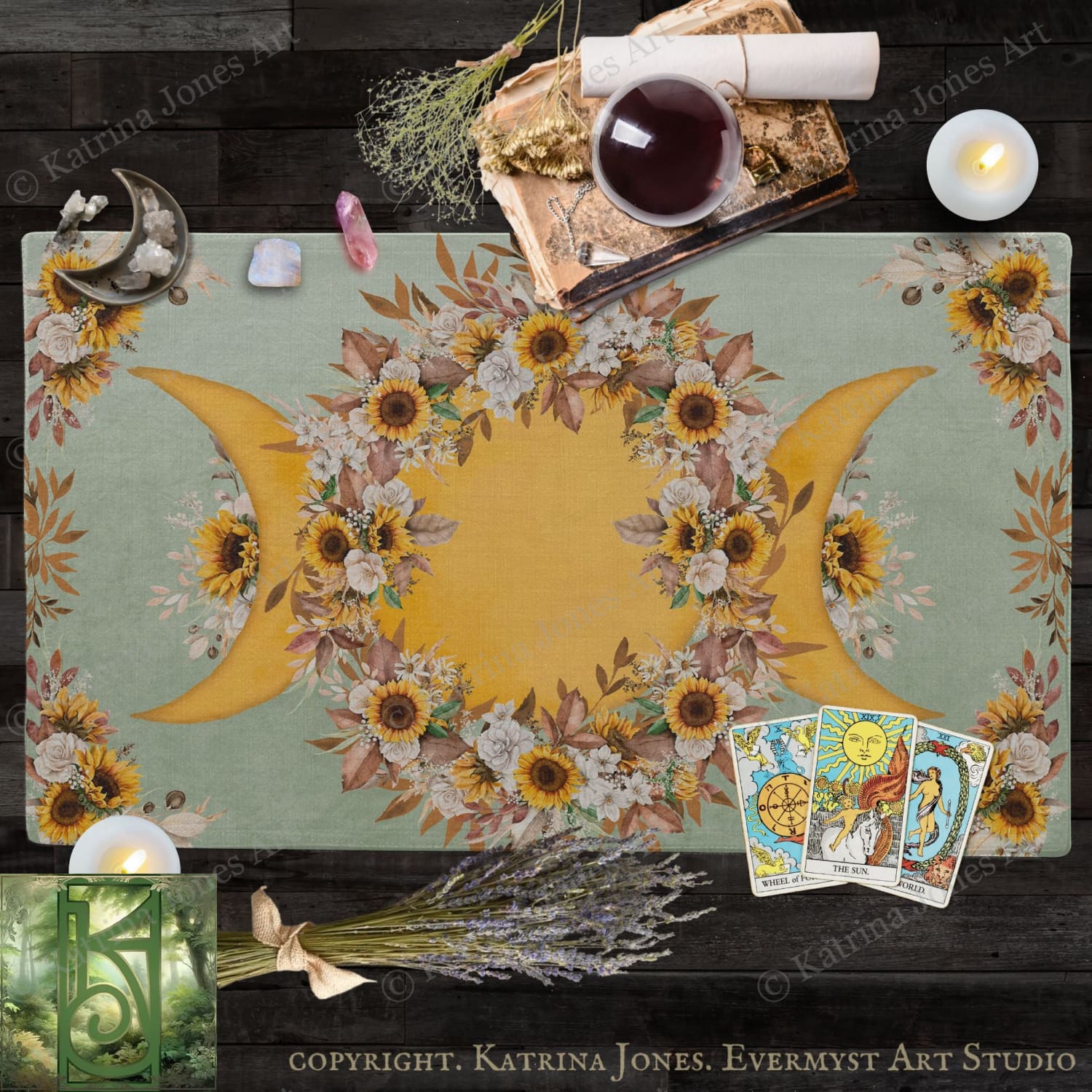 a table with a floral design, candles, and various objects, including a book, crystals, and tarot cards.