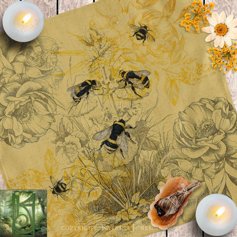 a table topped with bees and flowers next to candles